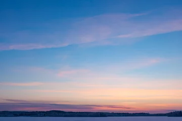 Foto auf Acrylglas Serene sunset sky at winter © Juhku