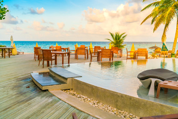 Table and chairs at restaurant in tropical Maldives island .