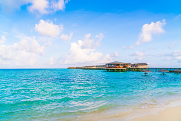 Beautiful water villas in tropical Maldives island at the sunris