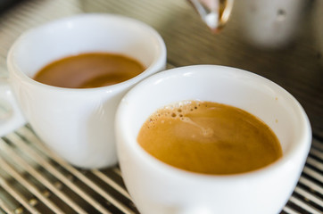 Barista making a cup of coffee soft focus image .