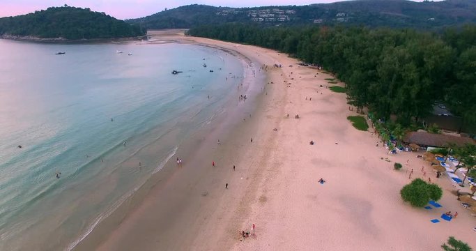 Aerial footage. Flying close over tropical sandy beach and waves. Thailand. Phuket. Layan beach. 4K