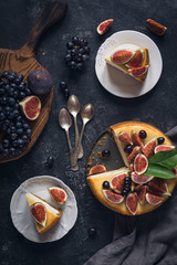 Cheesecake decorated with fresh fruits (figs and grapes). Top view, flat lay. Food still life