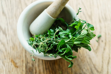 mortar with fresh herbs