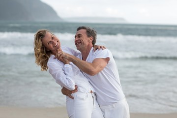 Mature couple having fun together at beach