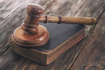 Law gavel on old brown leather book 