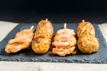 tasty kabobs with vegetables on a slate plate