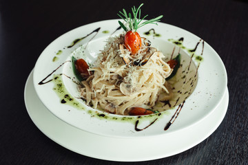 Pasta with mushrooms in a creamy sauce on a white plate