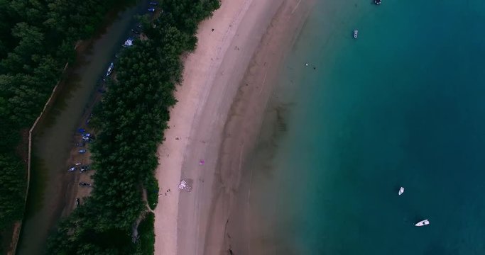 Aerial footage. Flying close over tropical sandy beach and waves. Thailand. Phuket. Layan beach. 4K