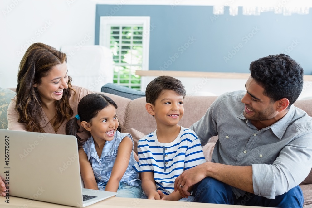 Sticker Parents and kids using laptop in living room