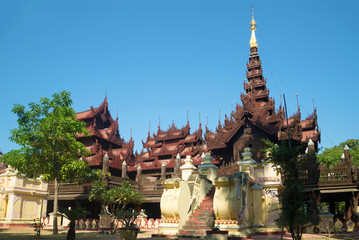 Old pagoda teak wood of Shwe In Bin Kyaung monastery a sunny day. Mandalay, Myanmar