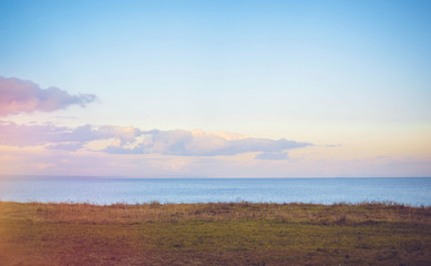 Sky background on sunset, seafront. Nature composition. Panoramic sunset sky background. Taganrog Bay, Azov sea. Beautiful sunset over sea with reflection in water, majestic clouds in the sky.