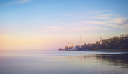Fototapeta premium Sky background on sunset, seafront. Nature composition. Panoramic sunset sky background. Taganrog Bay, Azov sea. Beautiful sunset over sea with reflection in water, majestic clouds in the sky.
