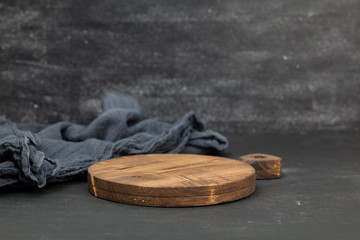 Wooden cutting board on a dark table.