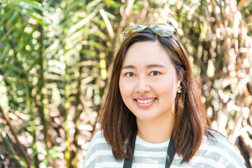 Woman smiling with perfect smile and white teeth in a park and l