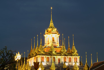 The top of the Chedi Loha Prasat buddhist temple Wat Ratchanadda against the evening sky. Bangkok, Thailand