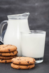Oatmeal chocolate chip cookies and milk jug. Healthy eating.