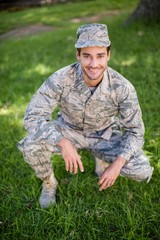 Naklejka na ściany i meble Portrait of soldier smiling in park
