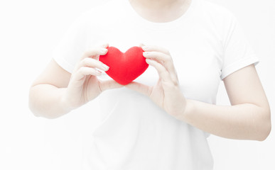 Woman holding and protecting a red heart shape on white background close-up,Symbol of love or dating Valentines day