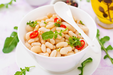 Boiled white beans in a bowl. Diet food. Healthy lifestyle. Sports nutrition.