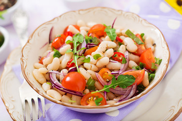 Salad of white beans, tomato, arugula, red onion  and pepper in bowl. Diet food. Healthy lifestyle. Sports nutrition.