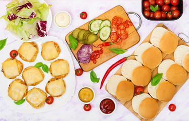 Ingredients for  hamburgers with chicken burger, cheese and  a vegetables. Flat lay. Top view.