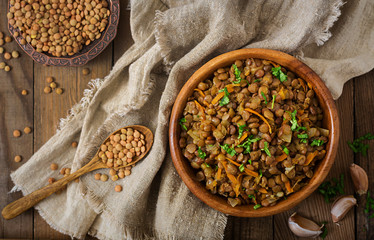 Lentil with carrot and onion in wooden bowl. Healthy lifestyle. Diet menu. Flat lay. Top view