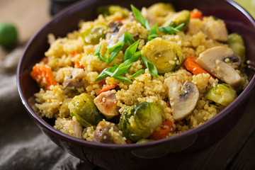 Vegetarian couscous salad with brussels sprouts, mushrooms, carrots and spices. Fitness food. Proper nutrition.
