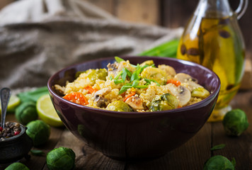 Vegetarian couscous salad with brussels sprouts, mushrooms, carrots and spices. Fitness food. Proper nutrition.