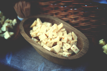 Cheese cubes in a wooden plate 