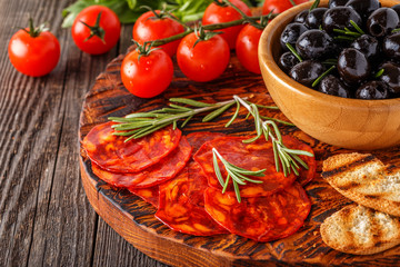 Spanish traditional chorizo sausage with fresh herbs, olives, to