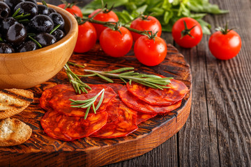 Spanish traditional chorizo sausage with fresh herbs, olives, to