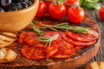 Spanish traditional chorizo sausage with fresh herbs, olives, to