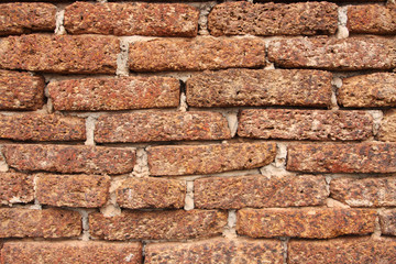 Old grunge laterite brick wall texture for background.