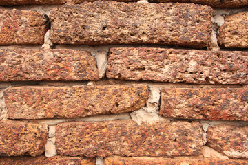 Old grunge laterite brick wall texture for background.