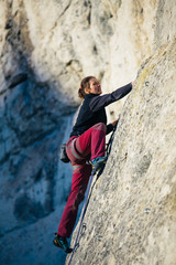 women climbs a rock