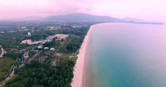 Aerial footage. Flying close over tropical sandy beach and waves. Thailand. Phuket. Layan beach. 4K
