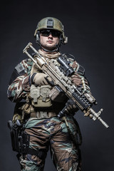 United states Marine Corps special operations command Marsoc raider with weapon. Studio shot of...