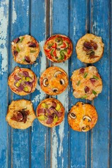 Various delicious italian pizza served on wooden plank