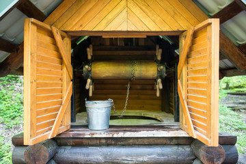 Old wooden well with  bucket