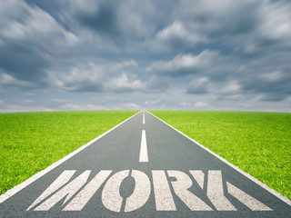 Work written on road in grass field against cloudy sky