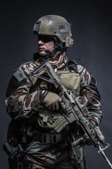 United states Marine Corps special operations command Marsoc raider with weapon. Studio shot of...