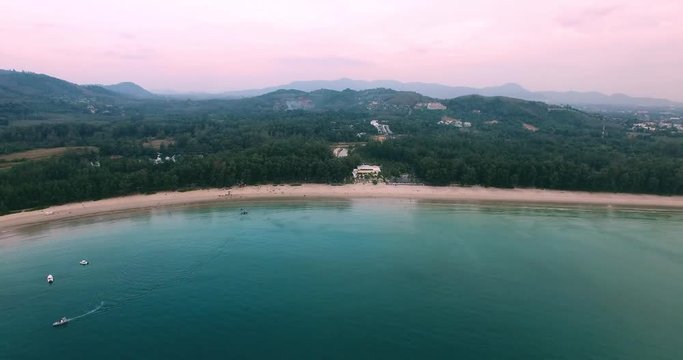 Aerial footage. Flying close over tropical sandy beach and waves. Thailand. Phuket. Layan beach. 4K