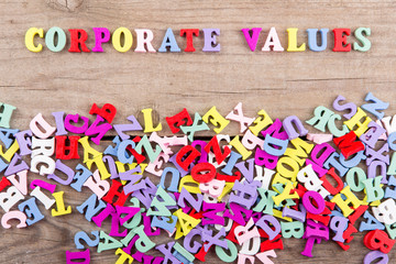 Text "Corporate values" of colored wooden letters on a wooden background