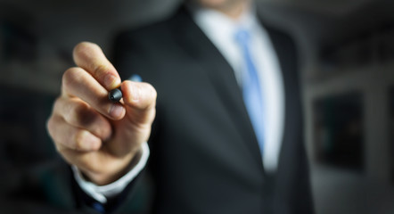 Businessman writing with a pen on a digital screen