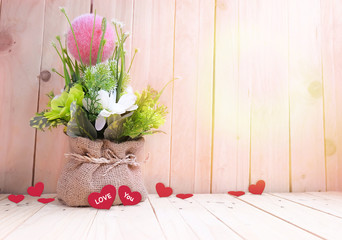 flowerpot with hearts on wood table,Valentine's day background.