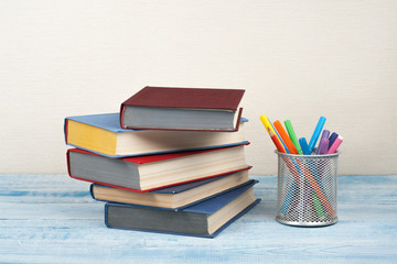 Book stacking. Open book, hardback books on wooden. Back to school. Copy space for text.