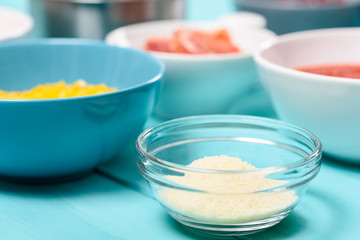 Parmesan Cheese And Food Ingredients On Turquoise Kitchen Table