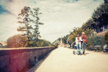 Young Parents With Baby Stroller In The Park
