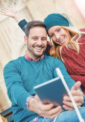Young loving couple taking a selfie with tablet. Love, dating, l