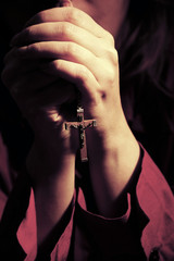 woman praying - prayer - with rosery with Christian cross